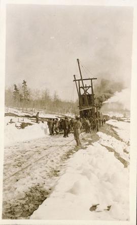 Several men working on the railroad tracks