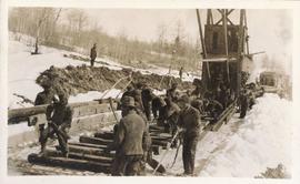 Several men working along the railroad tracks
