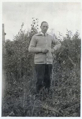 Man wearing a sweater standing in a field