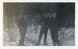 Three men standing in the snow