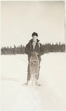 A man standing with his snow shoes