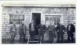 Several men standing in front of a building