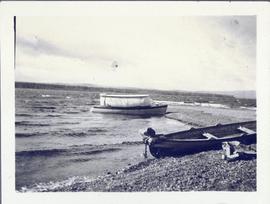 Two boats floating along the shore line