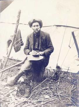 Man eating outside a tent
