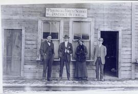 Three men and a woman standing in front of the Provincial Forest Service District Office