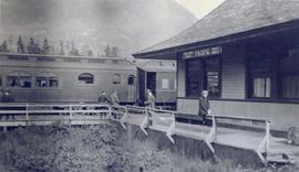 A woman sitting in front of the Prince Rupert train station
