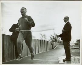 Ray Williston running through ribbon