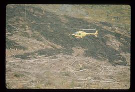 Woods Division - Fire - Helicopter hovering over logged landscape