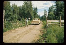 Woods Division - Timbercruising - Opening gate to allow truck to go through fence