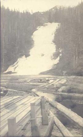 Waterfall behind log booms