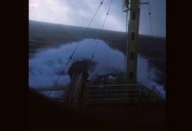 A wave about to break over the bow of a weather ship
