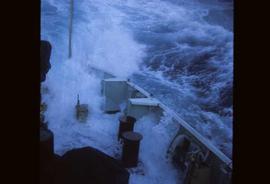 The bow of a weather ship swamped with water after a wave broke over the top of the bow