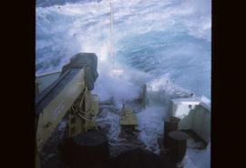 A wave while breaking over the bow of a weather ship