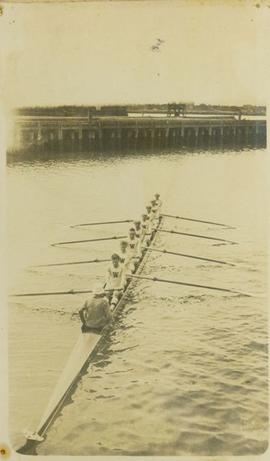 University of Washington rowing team sculling near wharf