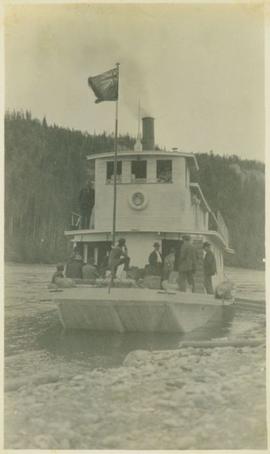 Ferry boat flying the Canadian Red Ensign with people on board