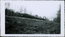Railroad ties being hauled past Red Rock on a flat bed BCR railcar