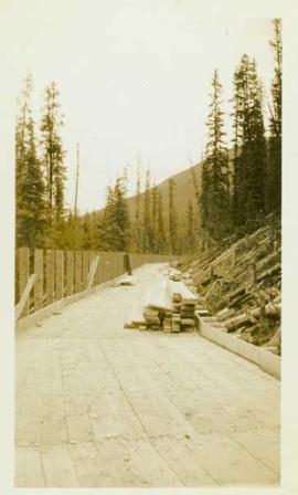 Construction of a wood planked flume 8ft.wide around the side of a mountain