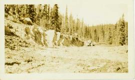 Ditch construction by bulldozer within a forested landscape