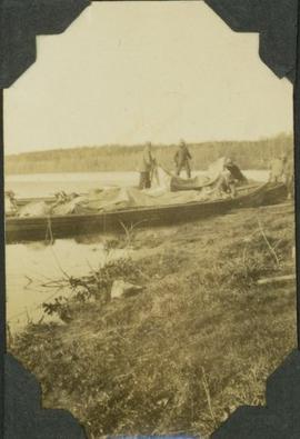Survey crew packing up canoe on MacLeod Lake