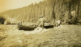 Three survey crewmen pulling the boat through the river