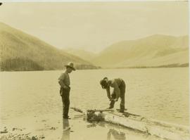Johnny Napolean  and Pete Callao building a makeshift raft on Muinok Lake