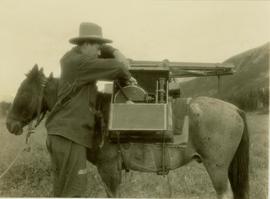 Prentiss Gray loading his camera equipment in a specially designed wooden box