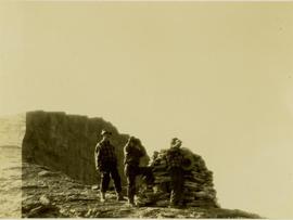 (L-R) Bob Potts, Joe (?) Callao and an unidentified man looking for game from a hilltop cairn