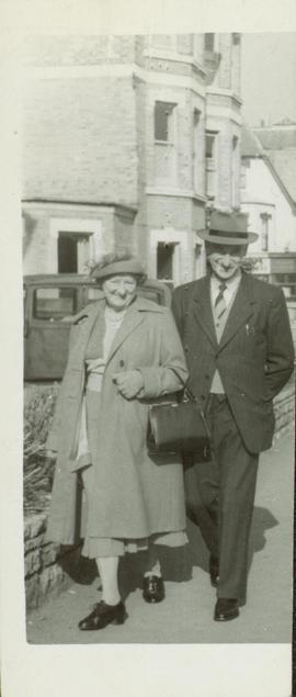 Family photographs from England: Lil & Jim Moore walking arm in arm down the street