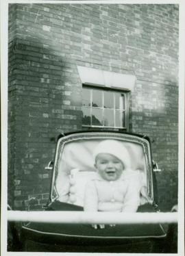 Family photographs from England: Baby John sitting up in his carriage