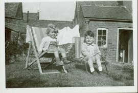 Family photographs from England: John and Christine sitting in lawn chairs