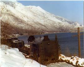 Canadian Pacific Railroad train on tracks alongside Kootenay Lake