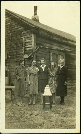 Hermina Taylor & Friends Stand Behind Cake