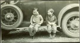 Young Alan and Fred Baxter sitting on car
