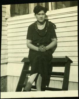 Violet Baxter Seated in Front of House