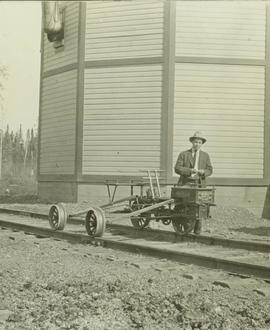 Man standing next to a hand car